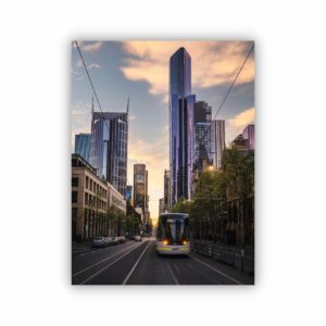 Canvas print of a photography of latrobe street at sunset showing off tall buildings in purple colours and victorian building on the right with city tram in the centre.