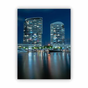 Wall decor canvas print of two big buildings at night time with beautiful lights.
