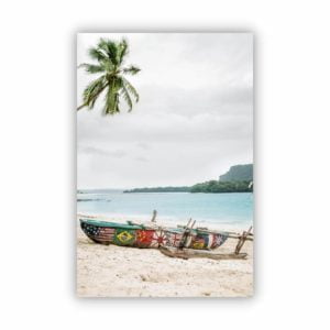 A portrait photo at a white sand beach with a colourful boat parked on the beach