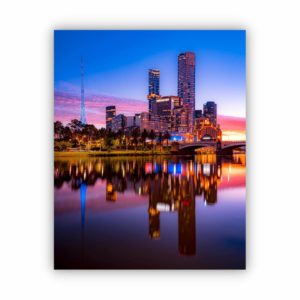 Image of building reflection on yarra river in blue and purple colours.