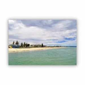 A photo of a beautiful beach view with cloudy blue sky and green fresh ocean water.