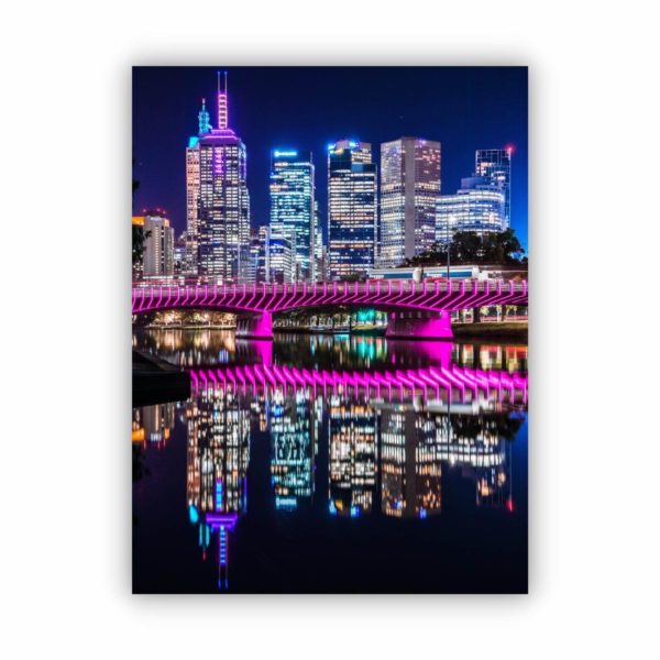 A photo of yarra river reflections of the purple bridge and city at night.
