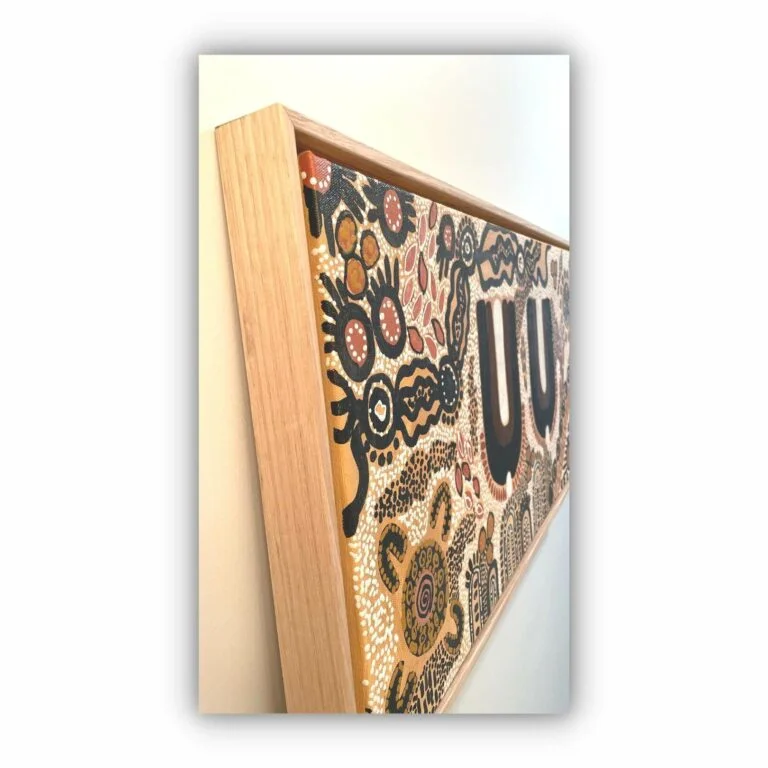 brown and orange aboriginal painting in raw oak frame