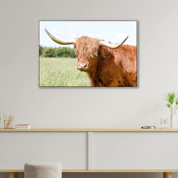 Golden brown highland cow with long white horns as an artwork.