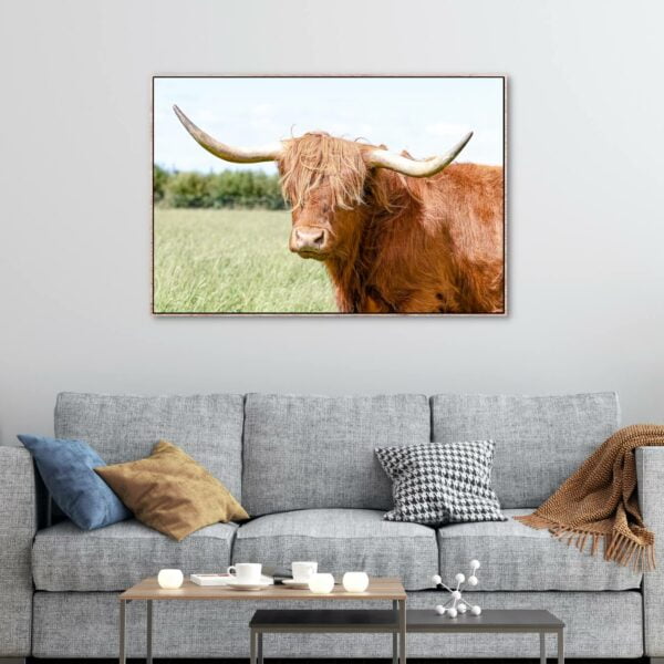 Golden brown highland cow with long white horns as an artwork.